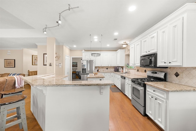 24418 Okehampton Dr, Tomball, TX 77375 - kitchen with stainless steel appliances, a kitchen island, crown molding, white cabinetry, and open floor plan