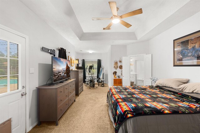 24418 Okehampton Dr, Tomball, TX 77375 - bedroom featuring light colored carpet, a raised ceiling, and a ceiling fan