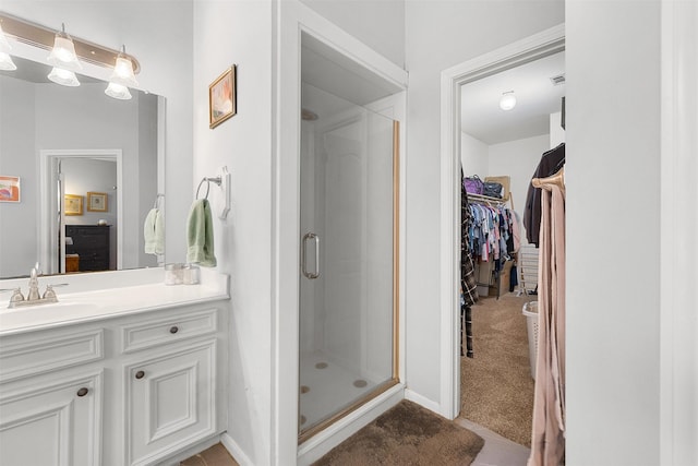 24418 Okehampton Dr, Tomball, TX 77375 - bathroom with a shower stall, vanity, and a walk in closet
