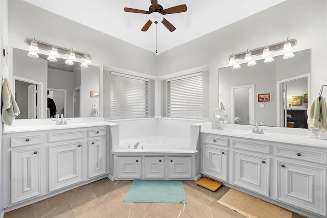 24418 Okehampton Dr, Tomball, TX 77375 - bathroom with ceiling fan, two vanities, and a bath