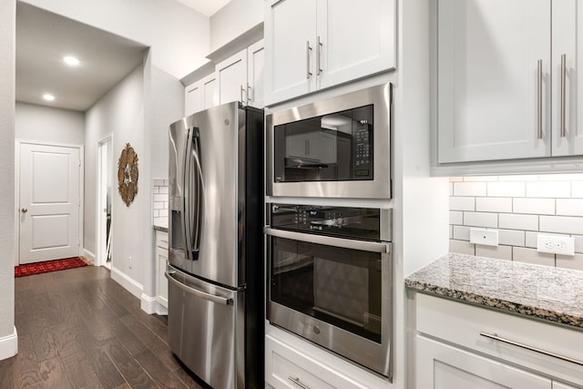 27688 Vivace Dr, Spring, TX 77386 - kitchen featuring stainless steel appliances, decorative backsplash, dark wood-style floors, light stone countertops, and recessed lighting
