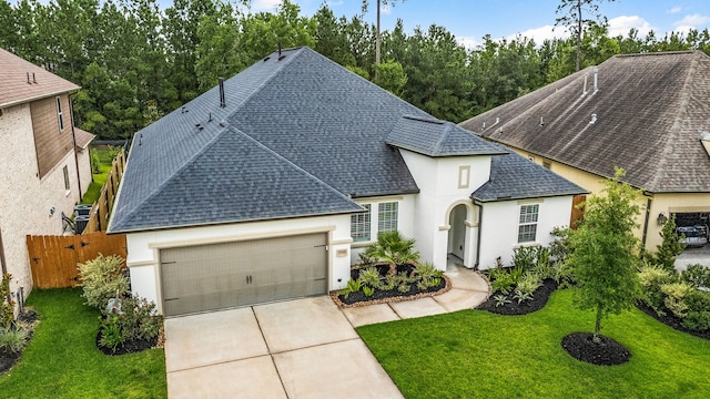 27688 Vivace Dr, Spring, TX 77386 - french country style house featuring a shingled roof, stucco siding, an attached garage, and driveway