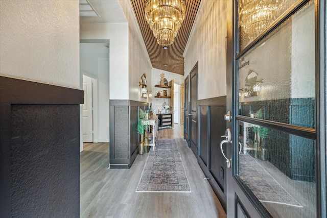 7203 Mayapple Grove Ln, Katy, TX 77493 - entrance foyer with a chandelier, light wood-style flooring, a high ceiling, and a textured wall