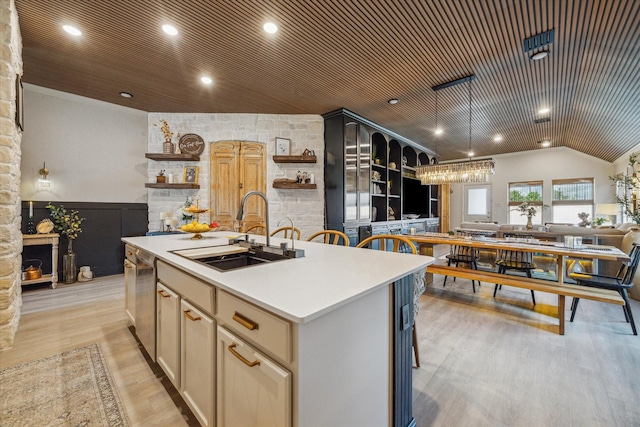 7203 Mayapple Grove Ln, Katy, TX 77493 - kitchen with open shelves, open floor plan, an island with sink, light wood-style flooring, and light countertops
