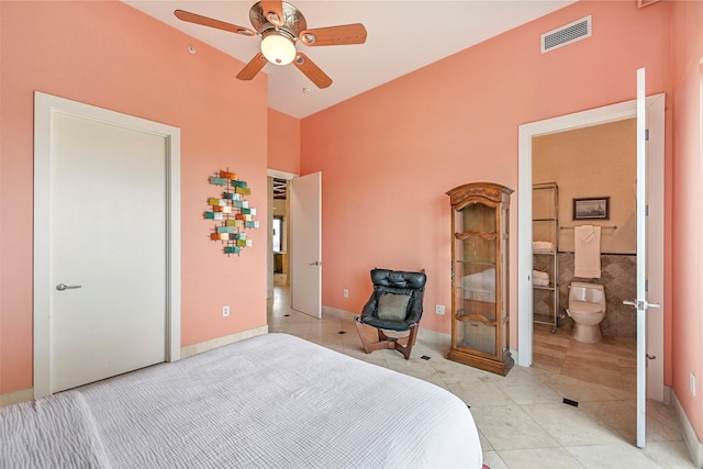4821 Nasa Pkwy Unit 18W, Seabrook, TX 77586 - bedroom with light tile patterned floors, a ceiling fan, and connected bathroom