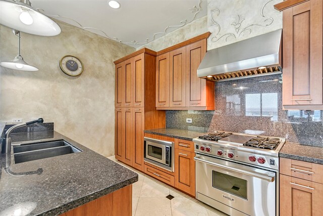 4821 Nasa Pkwy Unit 18W, Seabrook, TX 77586 - kitchen with appliances with stainless steel finishes, wall chimney range hood, brown cabinetry, tasteful backsplash, and light tile patterned floors