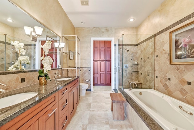 4821 Nasa Pkwy Unit 18W, Seabrook, TX 77586 - bathroom featuring tile walls, a stall shower, double vanity, a garden tub, and tile patterned floors