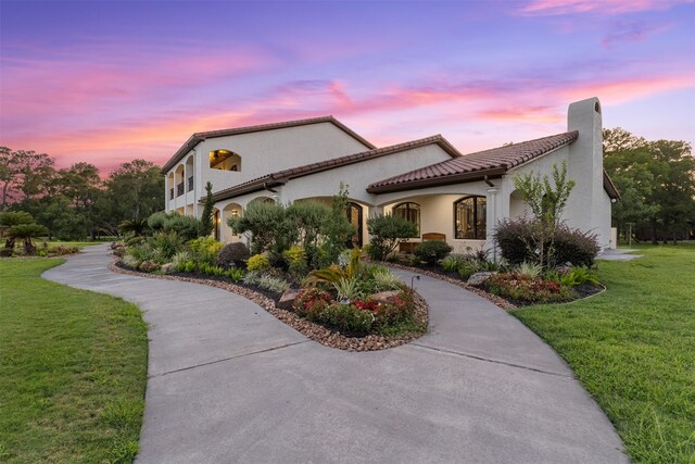 19216 Fm 442nd Rd, Needville, TX 77461 - view of front facade with a front yard, stucco siding, a chimney, curved driveway, and a tile roof