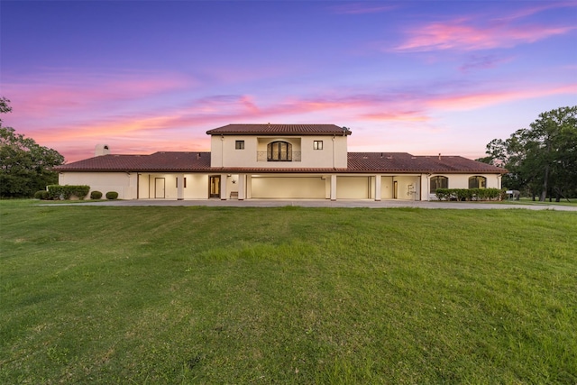 19216 Fm 442nd Rd, Needville, TX 77461 - mediterranean / spanish-style home with a tiled roof, driveway, a garage, a front lawn, and stucco siding