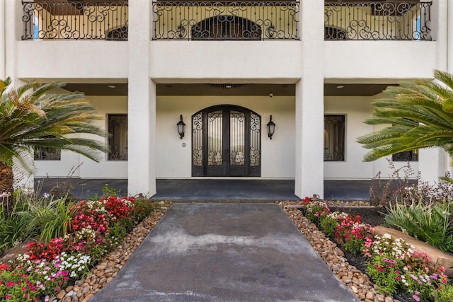 19216 Fm 442nd Rd, Needville, TX 77461 - doorway to property featuring a balcony, covered porch, and stucco siding