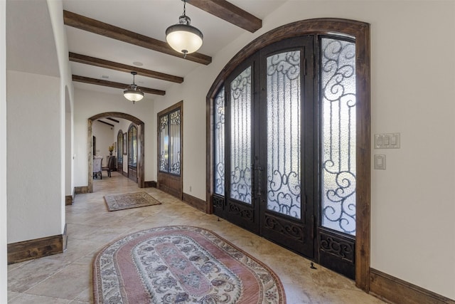 19216 Fm 442nd Rd, Needville, TX 77461 - entryway featuring french doors, arched walkways, beamed ceiling, and plenty of natural light