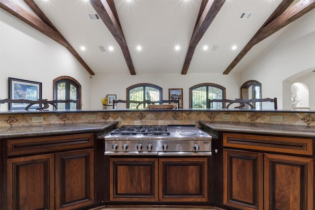 19216 Fm 442nd Rd, Needville, TX 77461 - kitchen with stainless steel gas stovetop, tasteful backsplash, recessed lighting, dark countertops, and arched walkways