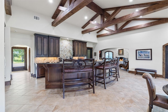 19216 Fm 442nd Rd, Needville, TX 77461 - kitchen with arched walkways, high vaulted ceiling, a breakfast bar, plenty of natural light, and a spacious island