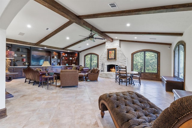 19216 Fm 442nd Rd, Needville, TX 77461 - living room with recessed lighting, ceiling fan, a stone fireplace, light tile patterned flooring, and arched walkways