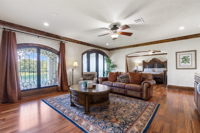 19216 Fm 442nd Rd, Needville, TX 77461 - living area with ceiling fan, french doors, hardwood / wood-style floors, a textured wall, and arched walkways