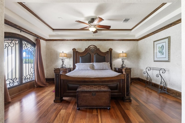 19216 Fm 442nd Rd, Needville, TX 77461 - bedroom featuring a tray ceiling, ornamental molding, wood finished floors, and a ceiling fan