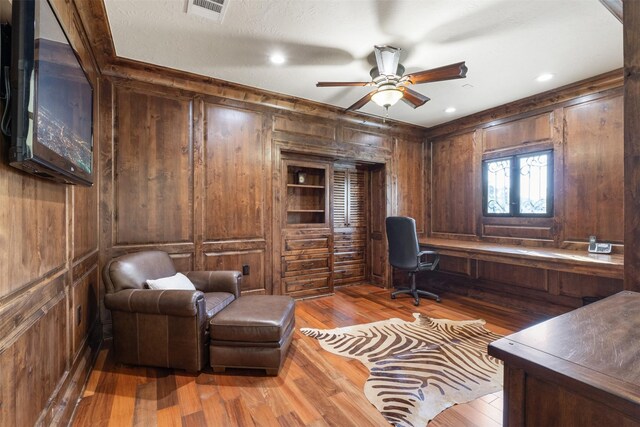 19216 Fm 442nd Rd, Needville, TX 77461 - home office featuring wooden walls, wood-type flooring, and a ceiling fan