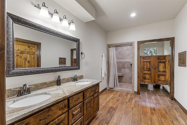 19216 Fm 442nd Rd, Needville, TX 77461 - full bathroom with wood finished floors, a stall shower, and double vanity