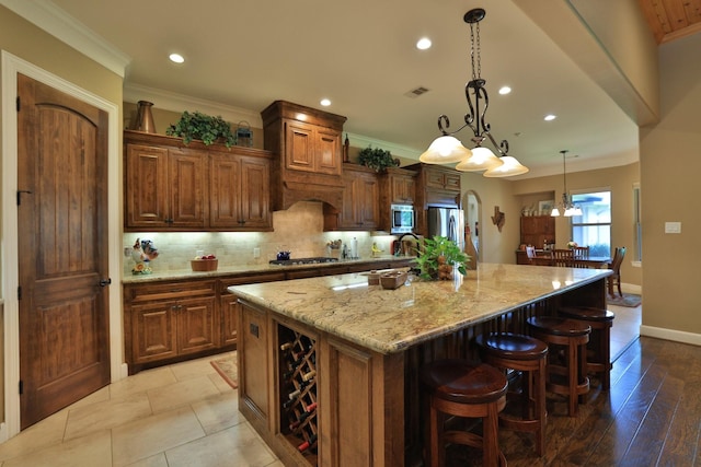16338 Acapulco Dr, Jersey Village, TX 77040 - kitchen with appliances with stainless steel finishes, a spacious island, recessed lighting, backsplash, and light stone countertops