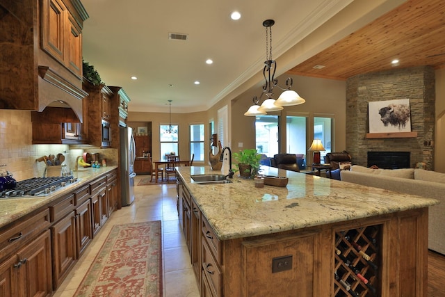 16338 Acapulco Dr, Jersey Village, TX 77040 - kitchen with stainless steel appliances, a kitchen island with sink, recessed lighting, decorative backsplash, and light stone countertops