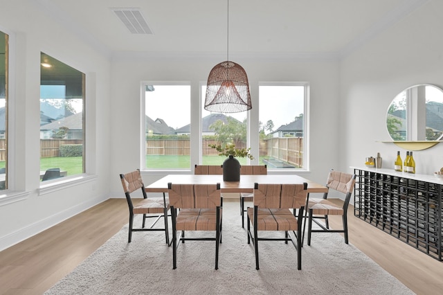 5212 Liberty Cove Dr, Spring, TX 77386 - dining area with wood finished floors, plenty of natural light, and crown molding