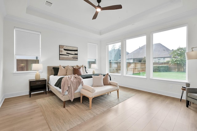 5212 Liberty Cove Dr, Spring, TX 77386 - bedroom with a raised ceiling, crown molding, light wood-type flooring, and ceiling fan