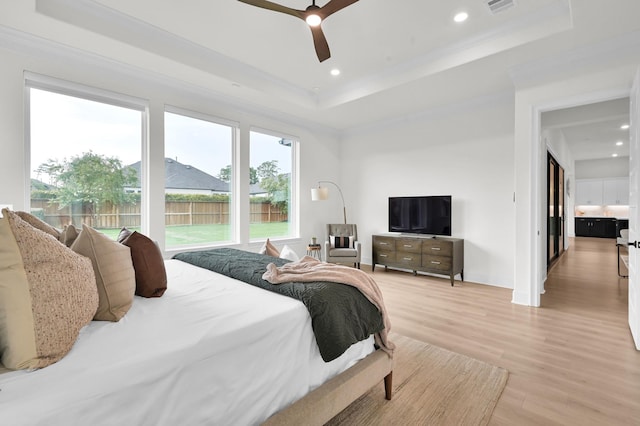5212 Liberty Cove Dr, Spring, TX 77386 - bedroom featuring a raised ceiling, light wood finished floors, recessed lighting, ornamental molding, and ceiling fan