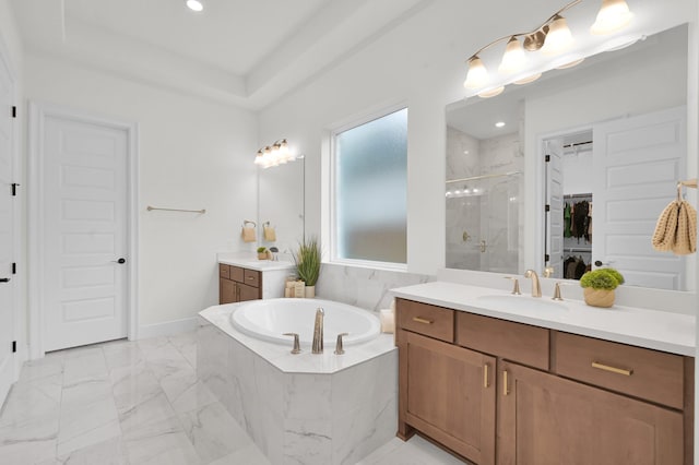 5212 Liberty Cove Dr, Spring, TX 77386 - bathroom featuring a marble finish shower, two vanities, a garden tub, marble finish flooring, and recessed lighting