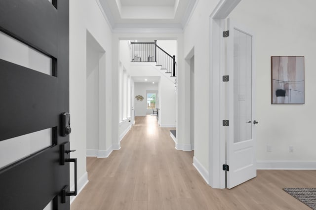 5212 Liberty Cove Dr, Spring, TX 77386 - hallway with light wood-style flooring, ornamental molding, a towering ceiling, and stairs