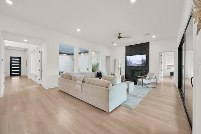 5212 Liberty Cove Dr, Spring, TX 77386 - living room with a ceiling fan, light wood-type flooring, recessed lighting, plenty of natural light, and a premium fireplace