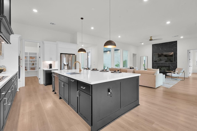 5212 Liberty Cove Dr, Spring, TX 77386 - kitchen featuring a ceiling fan, stainless steel fridge with ice dispenser, white cabinetry, light countertops, and light wood finished floors