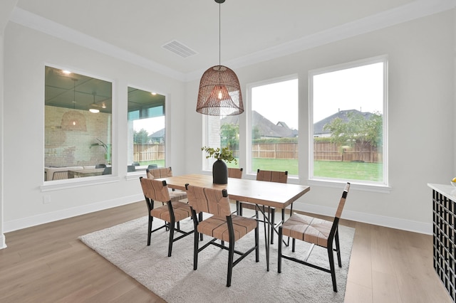 5212 Liberty Cove Dr, Spring, TX 77386 - dining area featuring healthy amount of natural light, wood finished floors, and crown molding