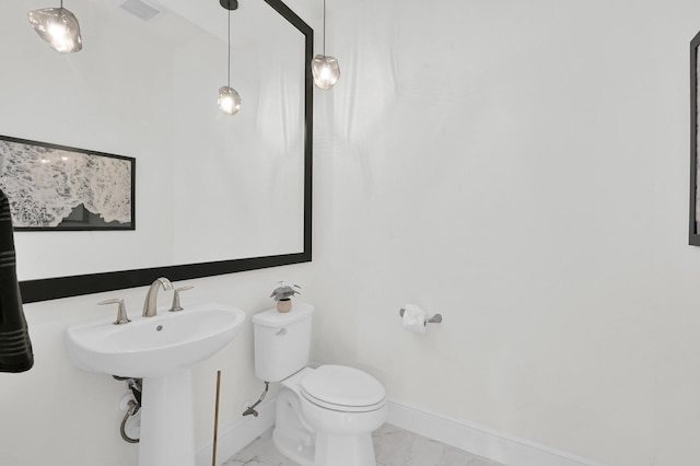 5212 Liberty Cove Dr, Spring, TX 77386 - bathroom featuring marble look tile flooring and toilet