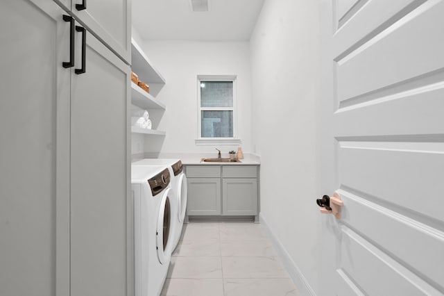 5212 Liberty Cove Dr, Spring, TX 77386 - laundry room featuring washer and dryer, light marble finish floors, and cabinet space