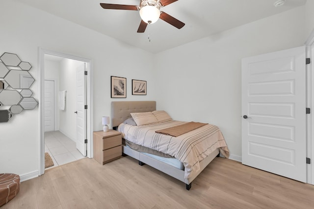 5212 Liberty Cove Dr, Spring, TX 77386 - bedroom featuring light wood-style floors, ensuite bathroom, and ceiling fan