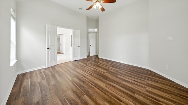 3119 Emory Oak Ln, Pearland, TX 77584 - unfurnished bedroom featuring dark wood finished floors, a ceiling fan, and a high ceiling