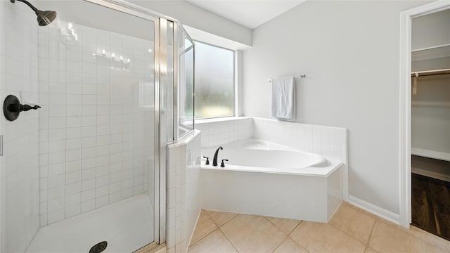 3119 Emory Oak Ln, Pearland, TX 77584 - full bathroom featuring a stall shower, a garden tub, tile patterned floors, and a spacious closet