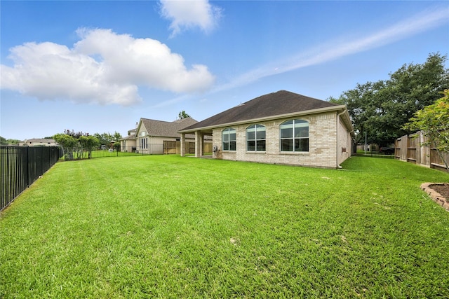 3119 Emory Oak Ln, Pearland, TX 77584 - rear view of house featuring a fenced backyard, brick siding, and a shingled roof