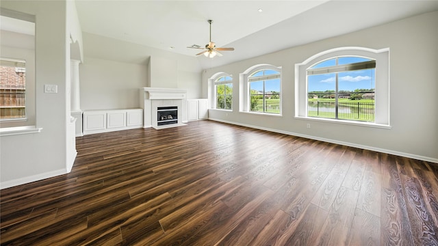 3119 Emory Oak Ln, Pearland, TX 77584 - unfurnished living room with a ceiling fan, dark wood-style floors, a fireplace, and high vaulted ceiling