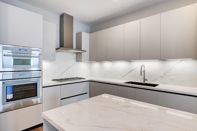 1711 Allen Pkwy Unit 2203, Houston, TX 77019 - kitchen featuring wall chimney exhaust hood, appliances with stainless steel finishes, modern cabinets, and light stone countertops