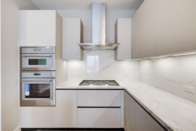 1711 Allen Pkwy Unit 2203, Houston, TX 77019 - kitchen with wall chimney exhaust hood, stainless steel appliances, modern cabinets, and backsplash