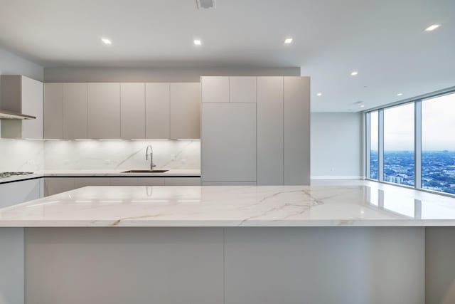 1711 Allen Pkwy Unit 2203, Houston, TX 77019 - kitchen with decorative backsplash, modern cabinets, light stone counters, recessed lighting, and floor to ceiling windows
