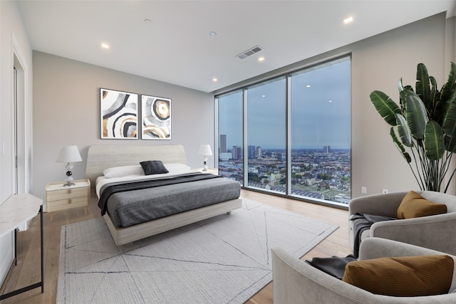 1711 Allen Pkwy Unit 2203, Houston, TX 77019 - bedroom with a wall of windows, light wood finished floors, recessed lighting, and a view of city