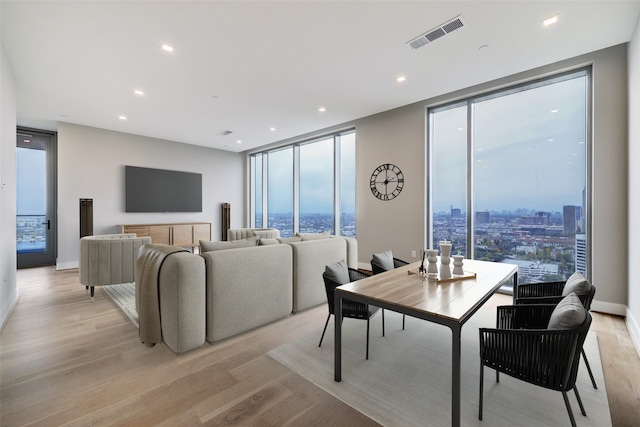 1711 Allen Pkwy Unit 2203, Houston, TX 77019 - dining area with a wall of windows, light wood-style floors, plenty of natural light, and recessed lighting