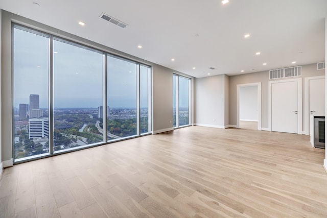 1711 Allen Pkwy Unit 2203, Houston, TX 77019 - unfurnished living room featuring light wood-style floors, floor to ceiling windows, and recessed lighting