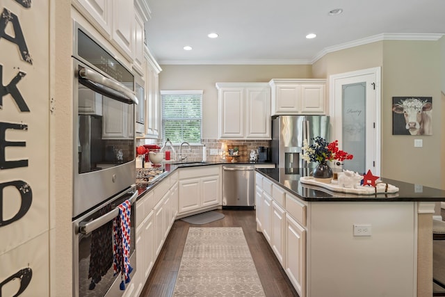 115 Dedication Trl, Huntsville, TX 77340 - kitchen with appliances with stainless steel finishes, recessed lighting, tasteful backsplash, dark wood-style floors, and a center island