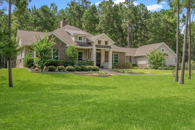 115 Dedication Trl, Huntsville, TX 77340 - view of front facade with a front yard, a chimney, a shingled roof, and stone siding