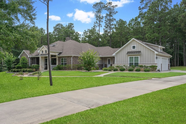 115 Dedication Trl, Huntsville, TX 77340 - view of front of property featuring board and batten siding, a front yard, driveway, an attached garage, and a chimney