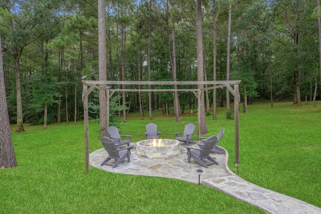 115 Dedication Trl, Huntsville, TX 77340 - view of green lawn featuring an outdoor fire pit and a patio area
