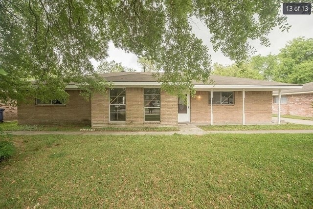 12911 Slater Ln, Houston, TX 77039 - rear view of property featuring a yard and brick siding